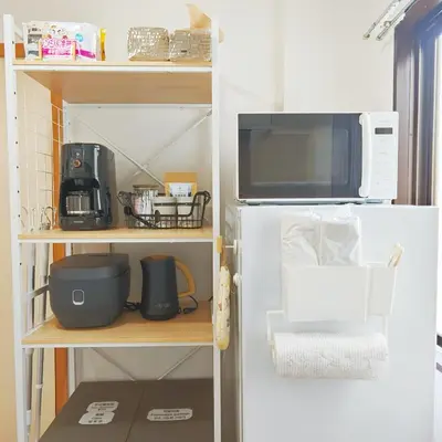 a kitchen with a microwave and a refrigerator at SkyTree-501 in Tokyo