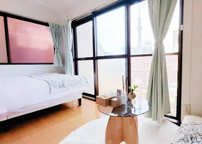 a bedroom with a bed and a glass table at SkyTree-501 in Tokyo