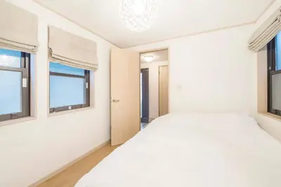 a bedroom with two beds and two windows at Yoyogi Detached house Y4BD in Tokyo