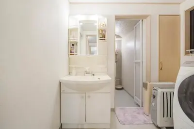 a white bathroom with a sink and a mirror at Yoyogi Detached house Y4BD in Tokyo