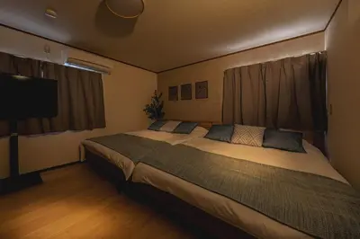 a bedroom with a large bed and a flat screen tv at Bnn\u5800\u52072\u4e01\u76eeESTA III in Tokyo