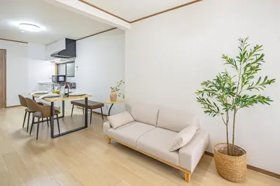a white living room with a couch and a table at Bnn\u5800\u52072\u4e01\u76eeESTA III in Tokyo