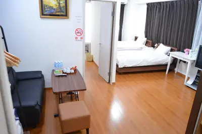 a small room with a bed and a table and a chair at \u677e\u8f1d\u65c5\u9928 in Tokyo