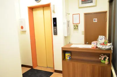 a hallway with a reception desk in a hospital room at \u677e\u8f1d\u65c5\u9928 in Tokyo
