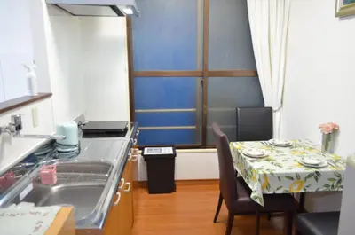 a kitchen with a sink and a table with a table cloth at \u677e\u8f1d\u65c5\u9928 in Tokyo