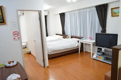 a small bedroom with a bed and a television at \u677e\u8f1d\u65c5\u9928 in Tokyo