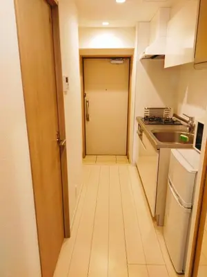 a small kitchen with a hallway leading to a door at Galicia Ryogoku Skytree View & Easy Access to Asakusa in Tokyo