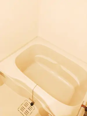 a white bath tub in a bathroom with a drain at Galicia Ryogoku Skytree View & Easy Access to Asakusa in Tokyo