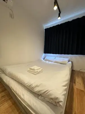 a bed with two towels on it in a room at Horizon Bleu Asakusa202 in Tokyo