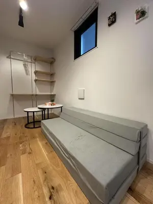 a bedroom with a bed and a table and a window at Horizon Bleu Asakusa202 in Tokyo