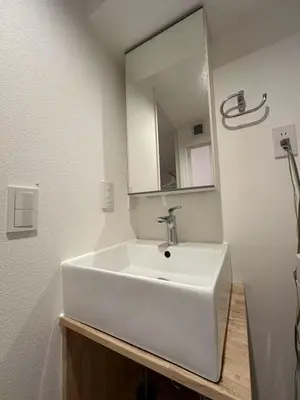 a bathroom with a white sink and a mirror at Horizon Bleu Asakusa202 in Tokyo