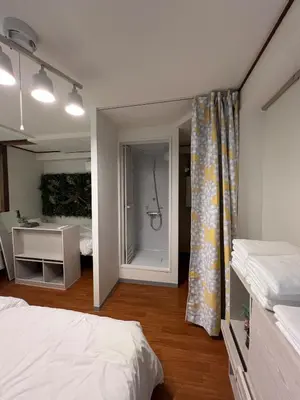 a bedroom with a bed and a desk and a mirror at Takashi Vada Home in Tokyo