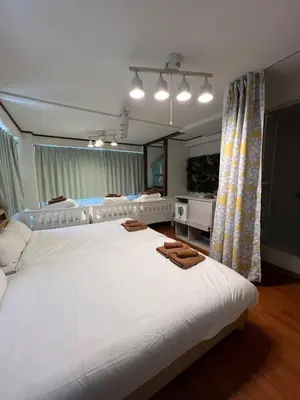 a large bedroom with two beds and a large mirror at Takashi Vada Home in Tokyo
