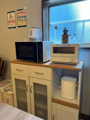 a counter with a microwave and a toaster oven on it at Takashi Vada Home in Tokyo