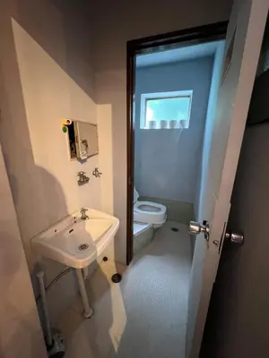 a bathroom with a sink and a toilet at Takashi Vada Home in Tokyo