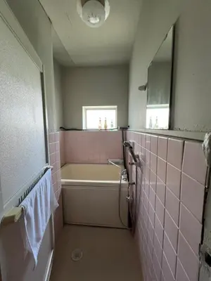a pink bathroom with a tub and a sink at Takashi Vada Home in Tokyo