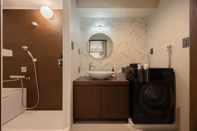 a bathroom with a sink and a toilet and a shower at Hotel Numero dix in Tokyo