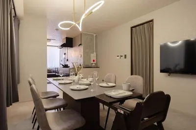 a dining room with a table with chairs and a dining room at Hotel Numero dix in Tokyo