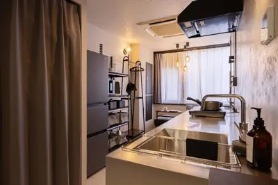 a kitchen with a sink and a counter top at Hotel Numero dix in Tokyo