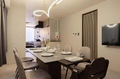 a dining room and kitchen with a table and chairs at Hotel Numero dix in Tokyo