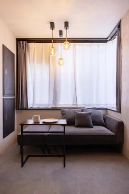 a couch in a room with a large window at Hotel Numero dix in Tokyo