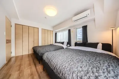 a bedroom with two beds and a window at Matcha Inn Sakura Tokyo 2 in Tokyo