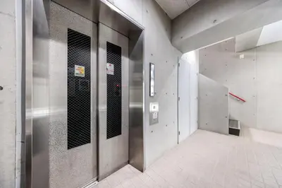 a hallway with metal doors in a building at Matcha Inn Sakura Tokyo 2 in Tokyo