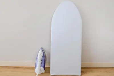 a white surfboard standing next to a white wall at Matcha Inn Sakura Tokyo 2 in Tokyo