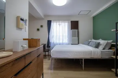 a bedroom with a bed and a sink and a window at CraftFlat Komagome 602, a compact studio at excellent location in Tokyo