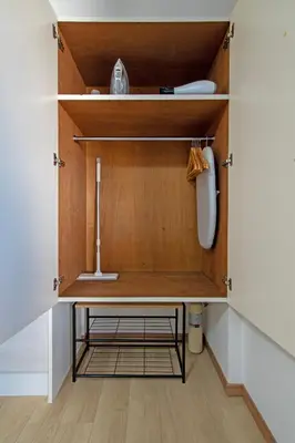 a closet with a wooden cabinet with a shelf at CraftFlat Komagome 602, a compact studio at excellent location in Tokyo