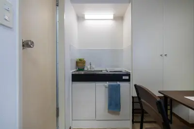 a small kitchen with a sink and a table at CraftFlat Komagome 602, a compact studio at excellent location in Tokyo