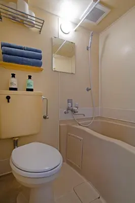 a bathroom with a toilet and a bath tub at CraftFlat Komagome 602, a compact studio at excellent location in Tokyo