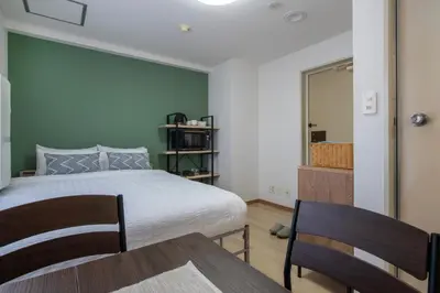 a bedroom with a bed and a table and chairs at CraftFlat Komagome 602, a compact studio at excellent location in Tokyo