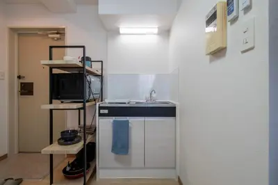 a kitchen with a sink and a microwave at CraftFlat Komagome 601, a compact studio at excellent location in Tokyo