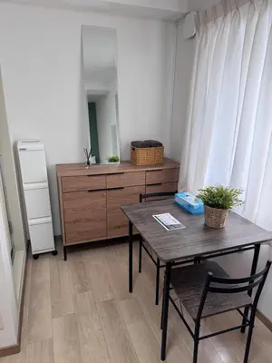 a room with a table and a dresser with a mirror at CraftFlat Komagome 601, a compact studio at excellent location in Tokyo