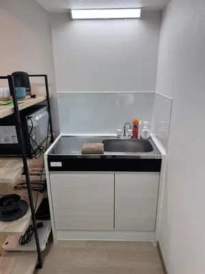 a kitchen with a sink and a shelf at CraftFlat Komagome 601, a compact studio at excellent location in Tokyo