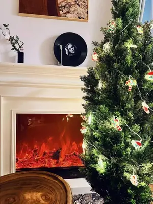 a christmas tree in front of a fireplace at ZQ2 Three min walk to subway, direct access to Asakusa, Ginza, Shinjuku, Ueno , super convenient transportation, 2 bathrooms 4 toilets, comfortable space in Tokyo