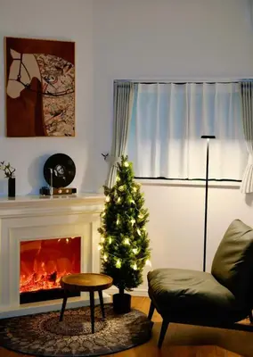 a living room with a christmas tree and a fireplace at ZQ2 Three min walk to subway, direct access to Asakusa, Ginza, Shinjuku, Ueno , super convenient transportation, 2 bathrooms 4 toilets, comfortable space in Tokyo