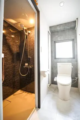 a bathroom with a toilet and a shower at Hotel iemirai Araiyakushi - Shinjuku 9min train ride in Tokyo