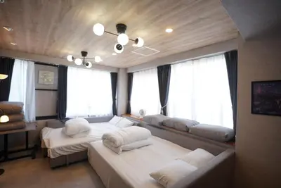 a room with two beds in a room with windows at Hotel iemirai Araiyakushi - Shinjuku 9min train ride in Tokyo