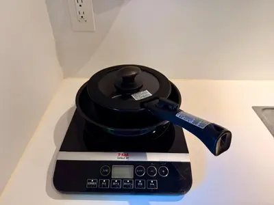 a coffee maker sitting on top of a table at Shibuya Simplex 3F, sunlight and 2 beds in Tokyo