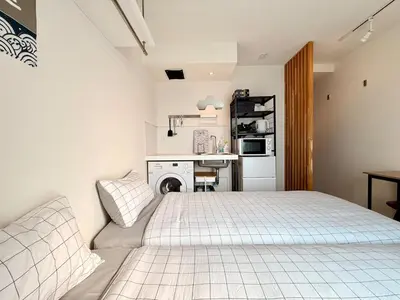 a white bedroom with a bed and a desk at Shibuya Simplex 3F, sunlight and 2 beds in Tokyo