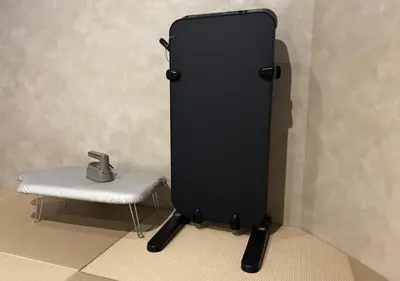 a black refrigerator next to a chair and a table at Sugoi Sauna And Stay Azabu-Juban Station, Men Only in Tokyo