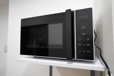a microwave oven sitting on top of a shelf at \u56db\u5b63\u5b89\u3005 in Tokyo