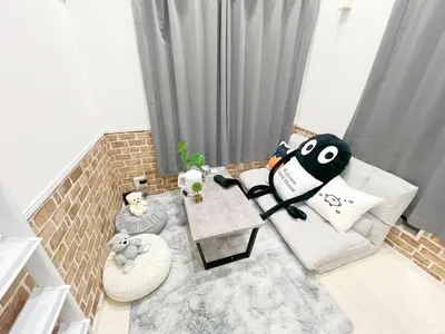 a living room with a couch and a table at AAo HalfSea in Tokyo