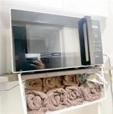 a microwave on top of a shelf with donuts at AAo HalfSea in Tokyo