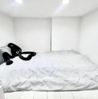 a bed with a black belt on top of it at AYooci o7 in Tokyo
