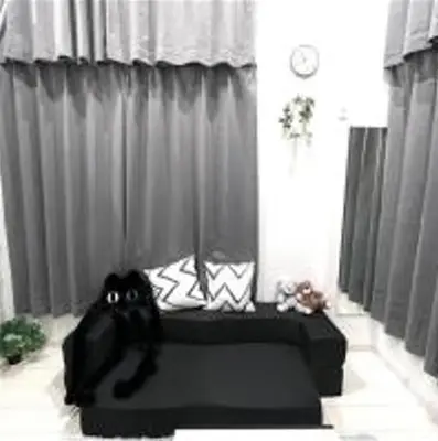 a black bed in a room with curtains at AYooci o7 in Tokyo