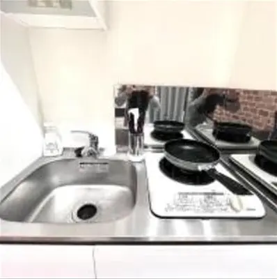 a kitchen counter with a sink and a stove at \u3072\u3060\u307e\u308a One in Tokyo