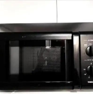 a black microwave oven sitting on top of a counter at \u3072\u3060\u307e\u308a One in Tokyo